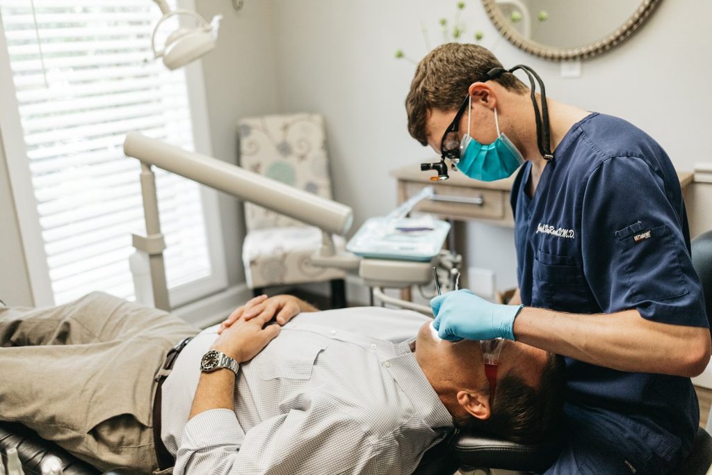 Dr. John DuRant performing a dental procedure on a patient at Cross County Dentistry in North Charleston, SC