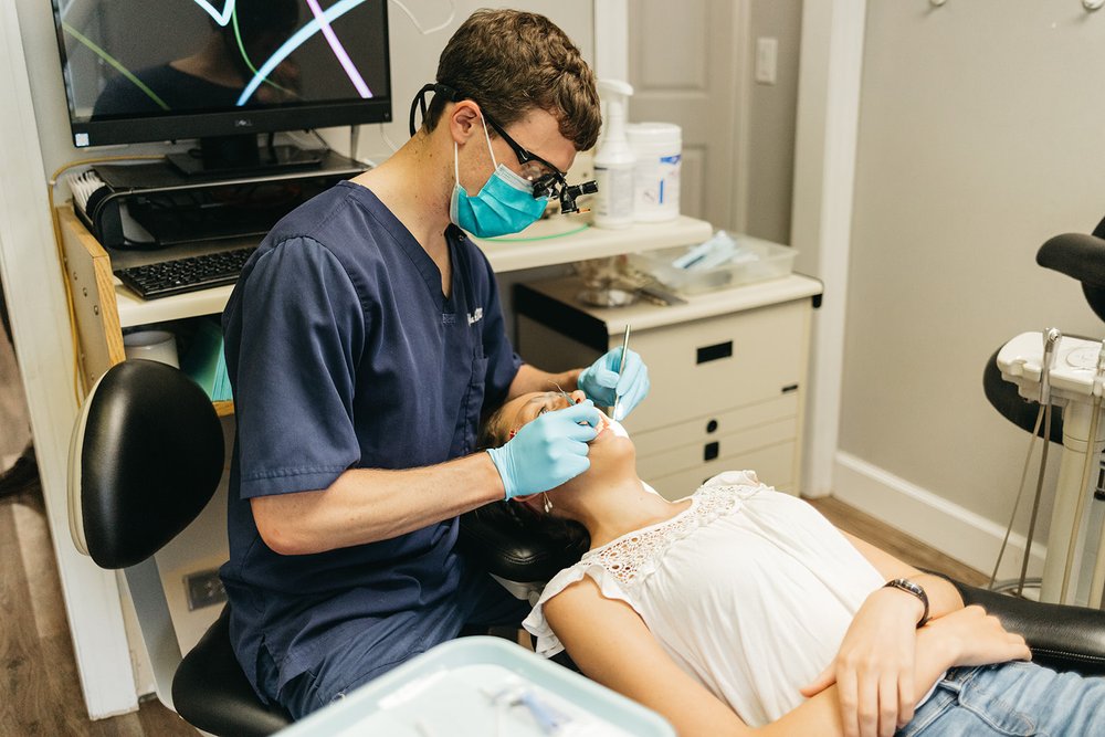 Dr. John DuRant performing a dental procedure on a patient at Cross County Dentistry in North Charleston, SC