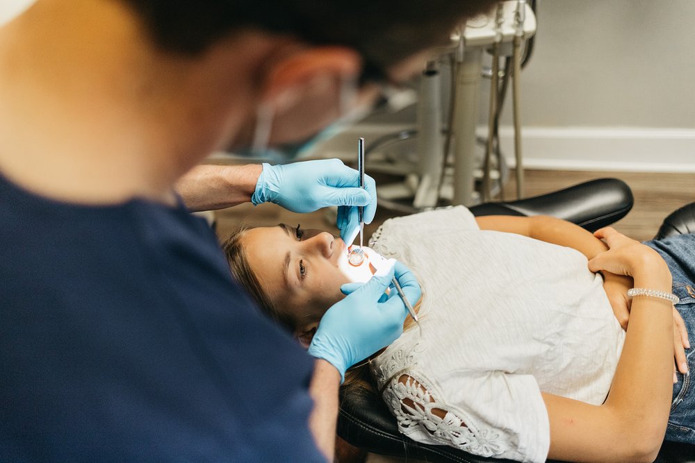 Dr. John DuRant performing a dental checkup on a young patient at Cross County Dentistry in North Charleston, SC