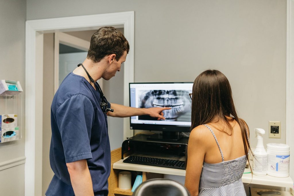 Dr. John DuRant reviewing a dental x-ray on a computer with a patient at Cross County Dentistry in North Charleston, SC