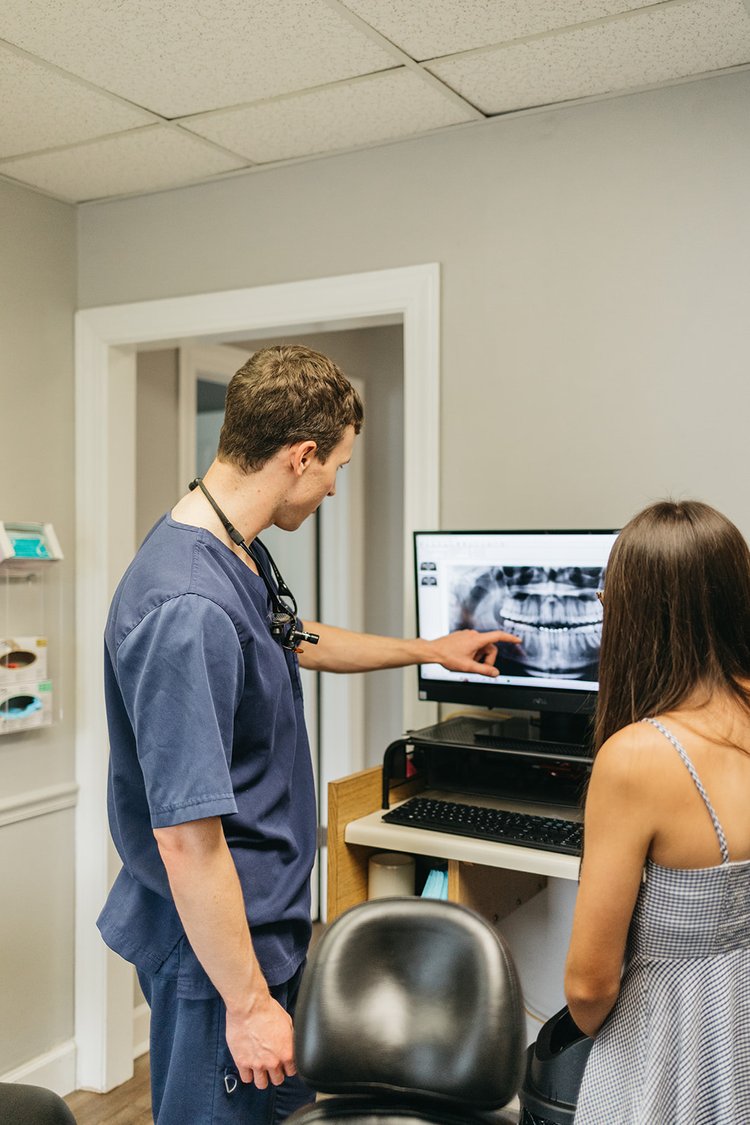 Dr. John DuRant showing a dental x-ray to a patient at Cross County Dentistry in North Charleston, SC