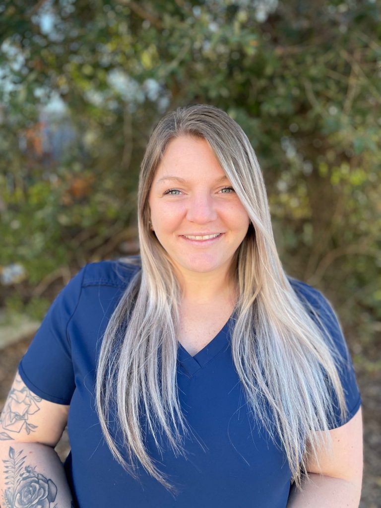 Shelby Meree, Office Coordinator at Cross County Dentistry, smiling outdoors